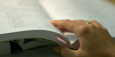 Picture of hand leafing through book