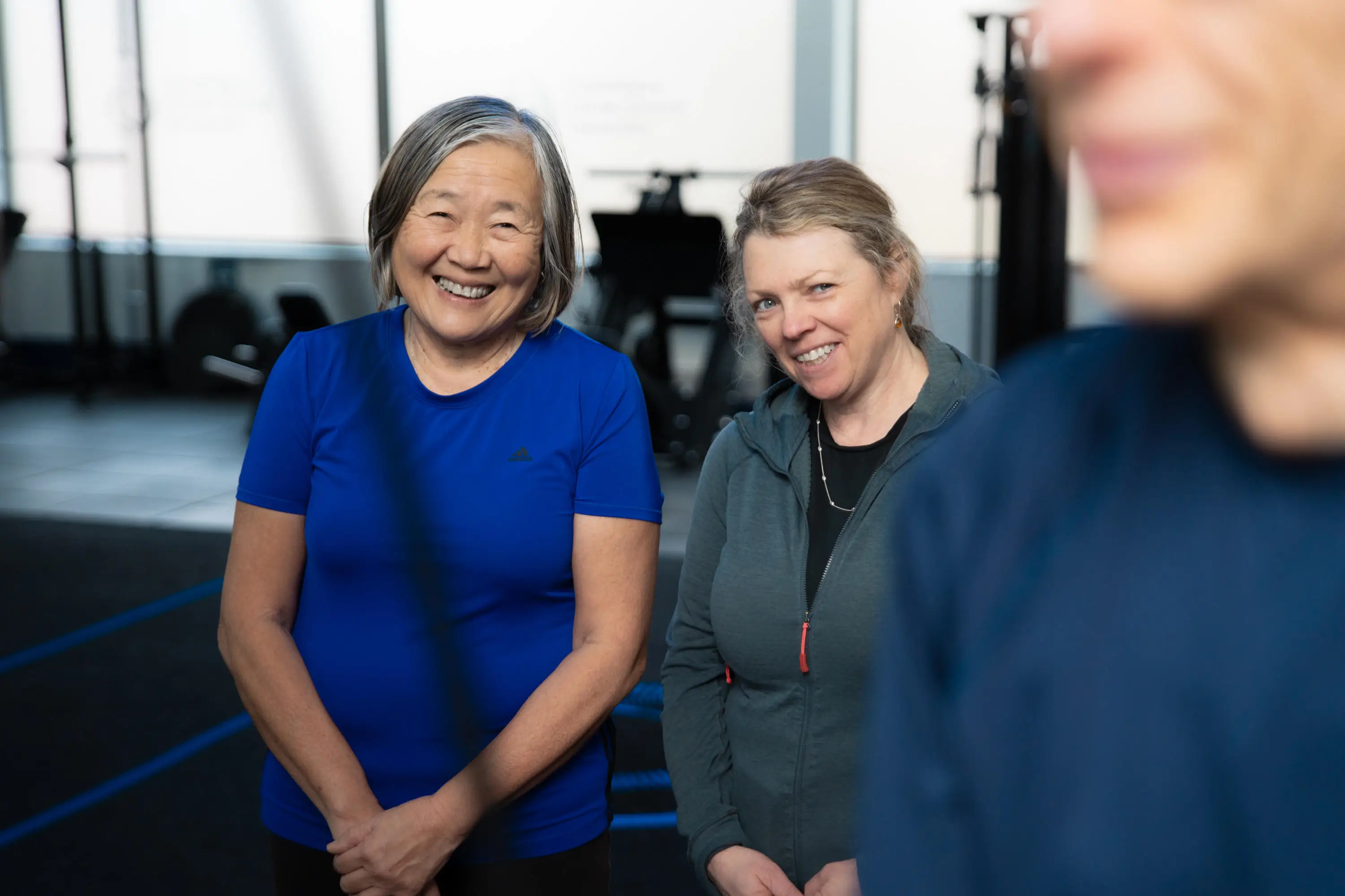 Two Fit for Life participants smiling at another participant