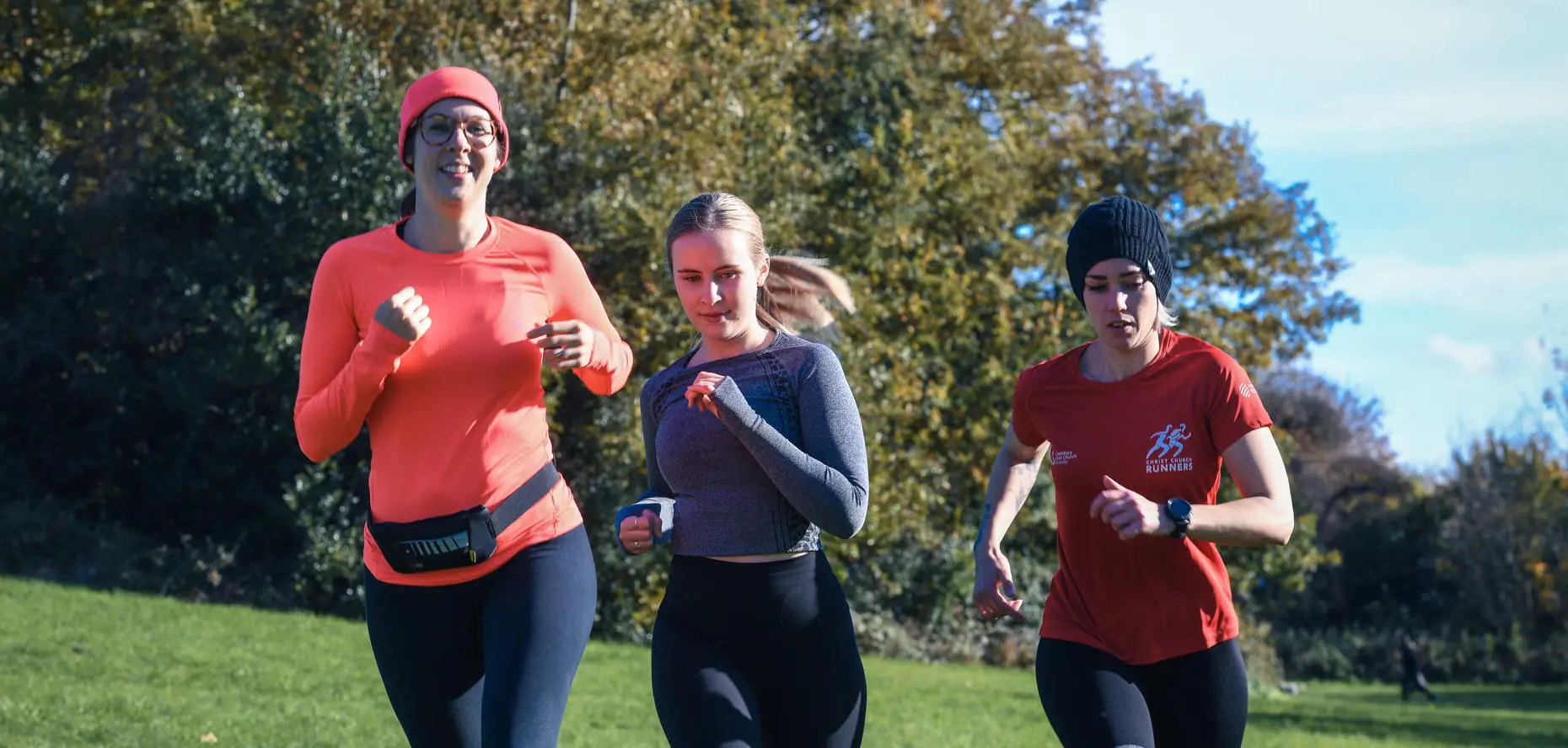 Three women running in a park