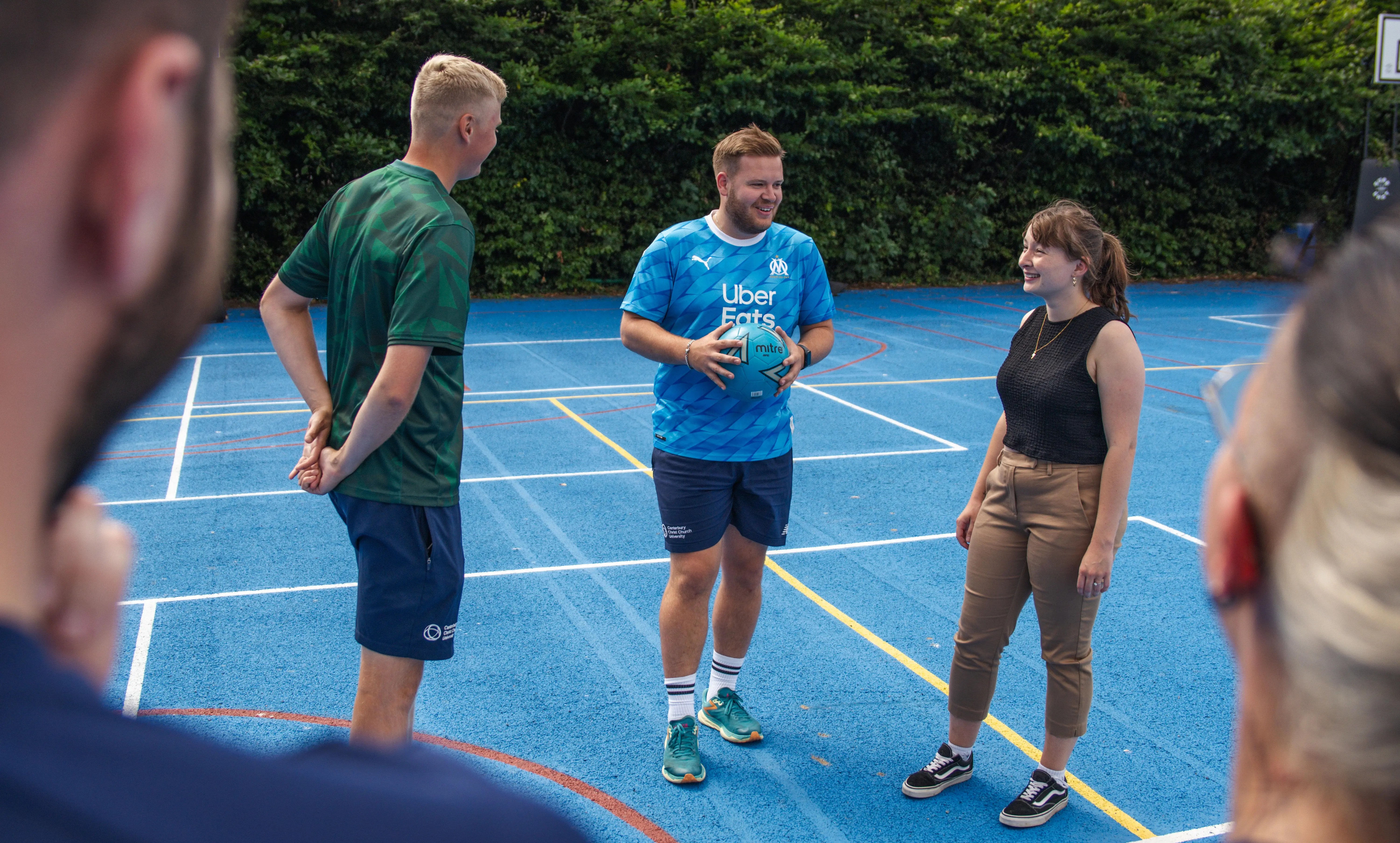 A group of people on the MUGA court