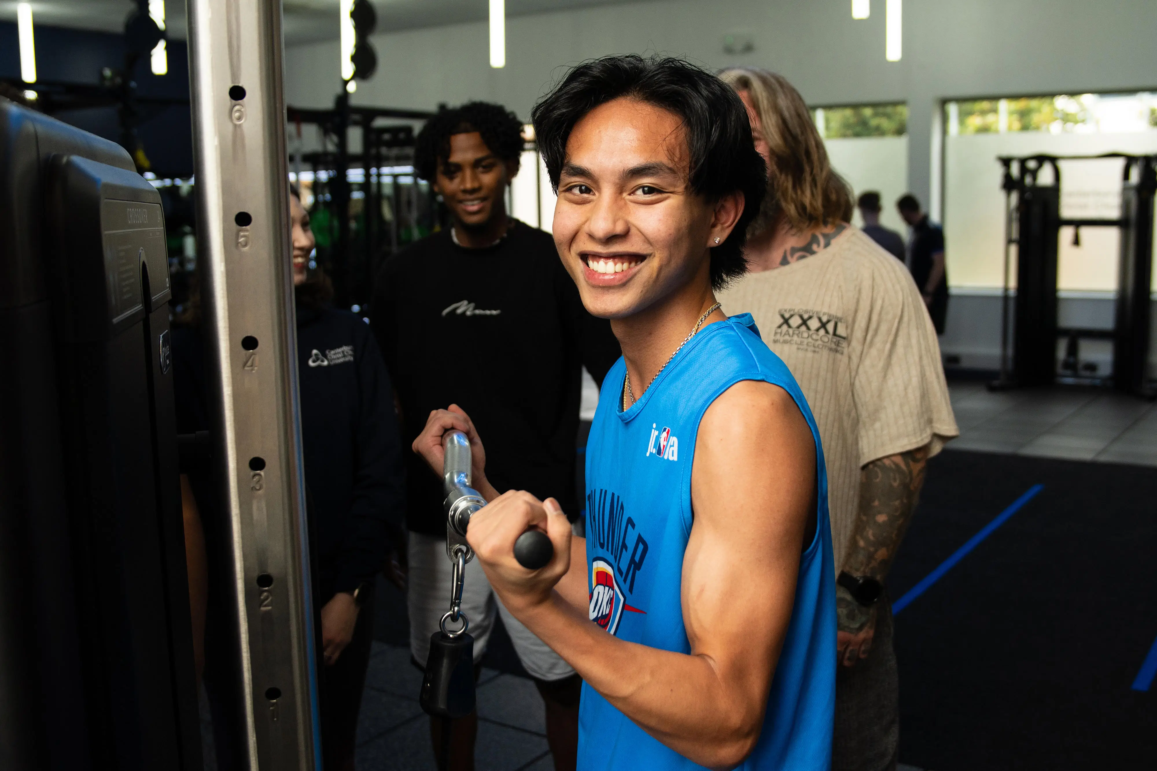 A person using weight machine smiling to the camera