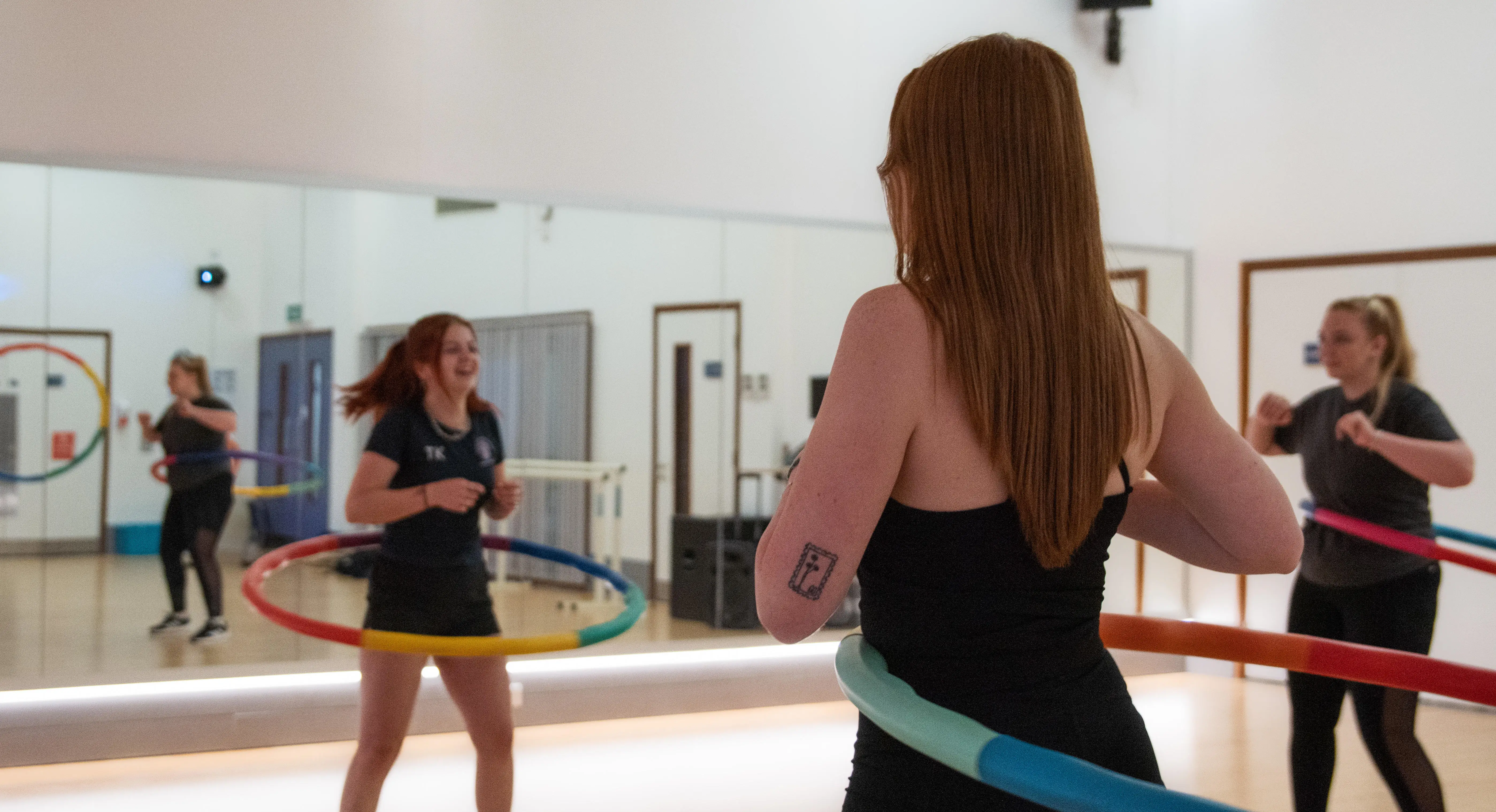 girls in a hula hooping in the dance studio