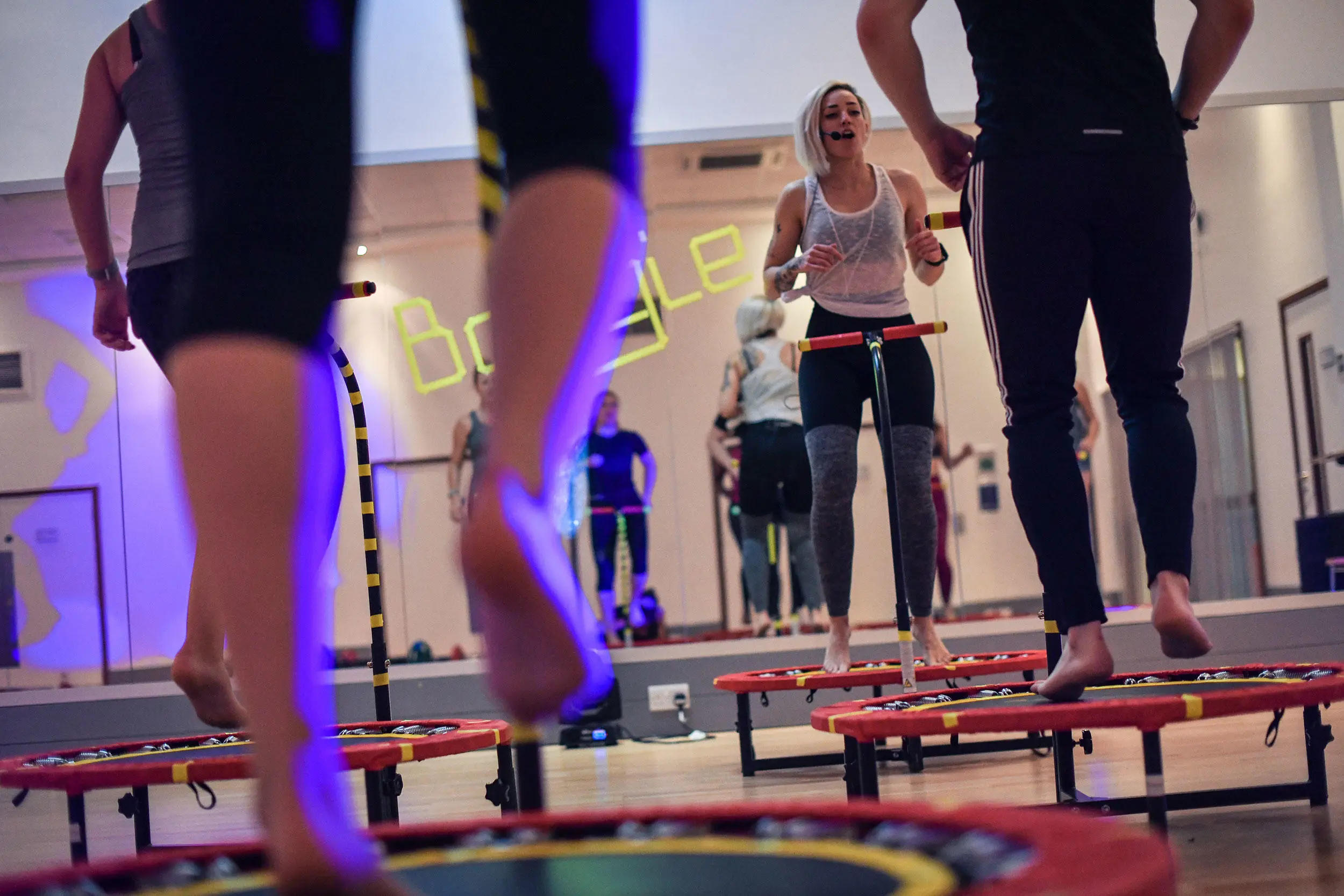 People jumping on trampolines as part of a fitness class.
