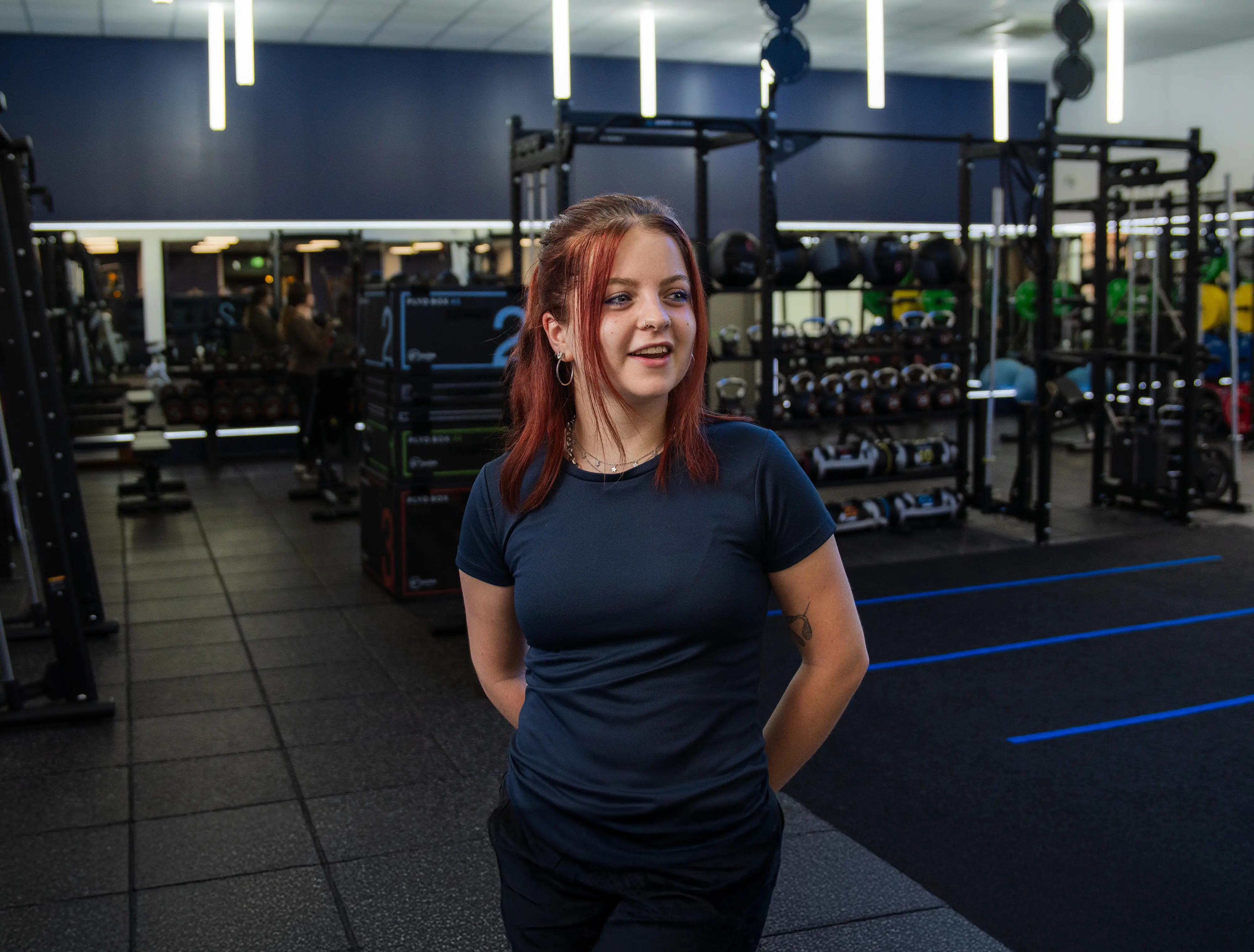 Women standing in the middle of the gym