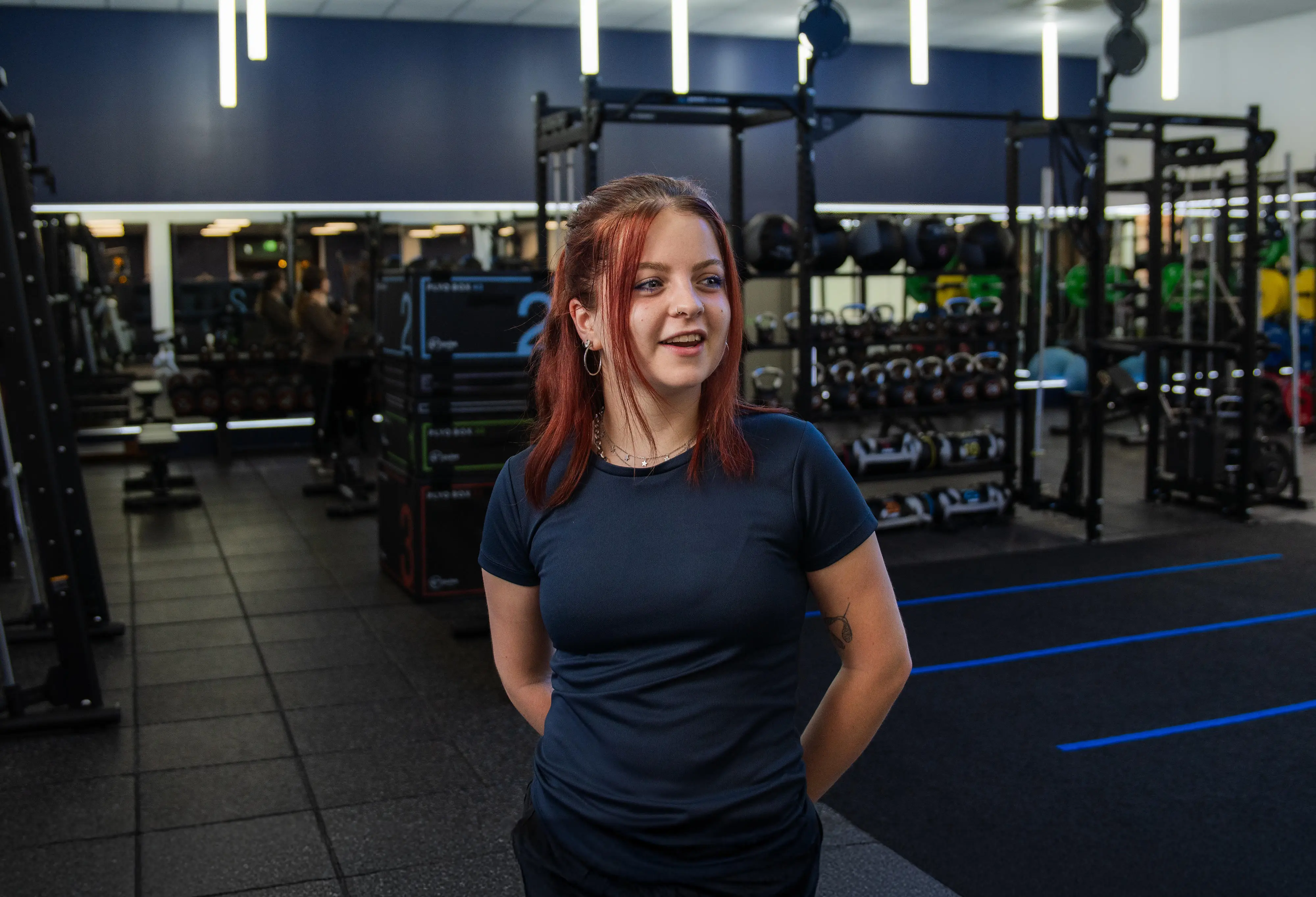 A women stood in the middle of the gym