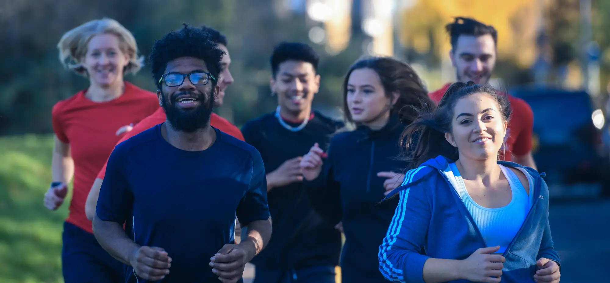 A group of people running on pavement