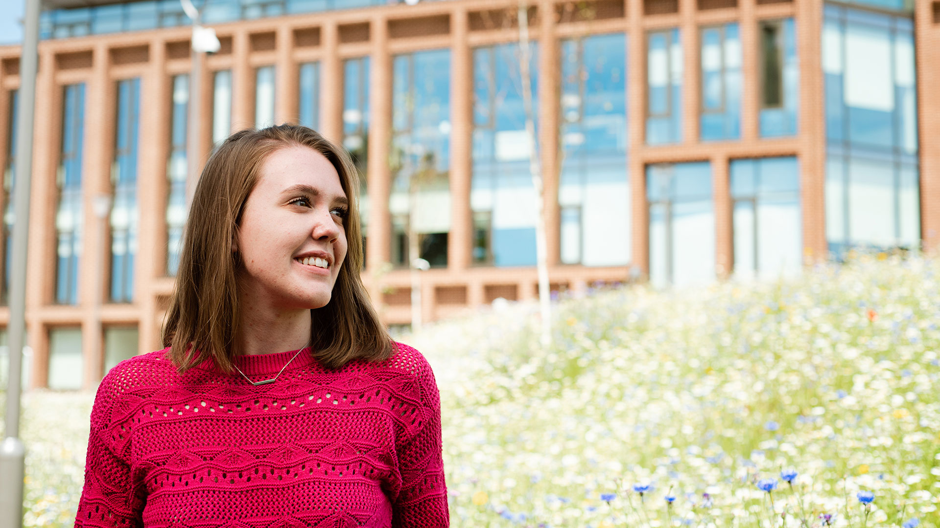 Student outside Verena Holmes building