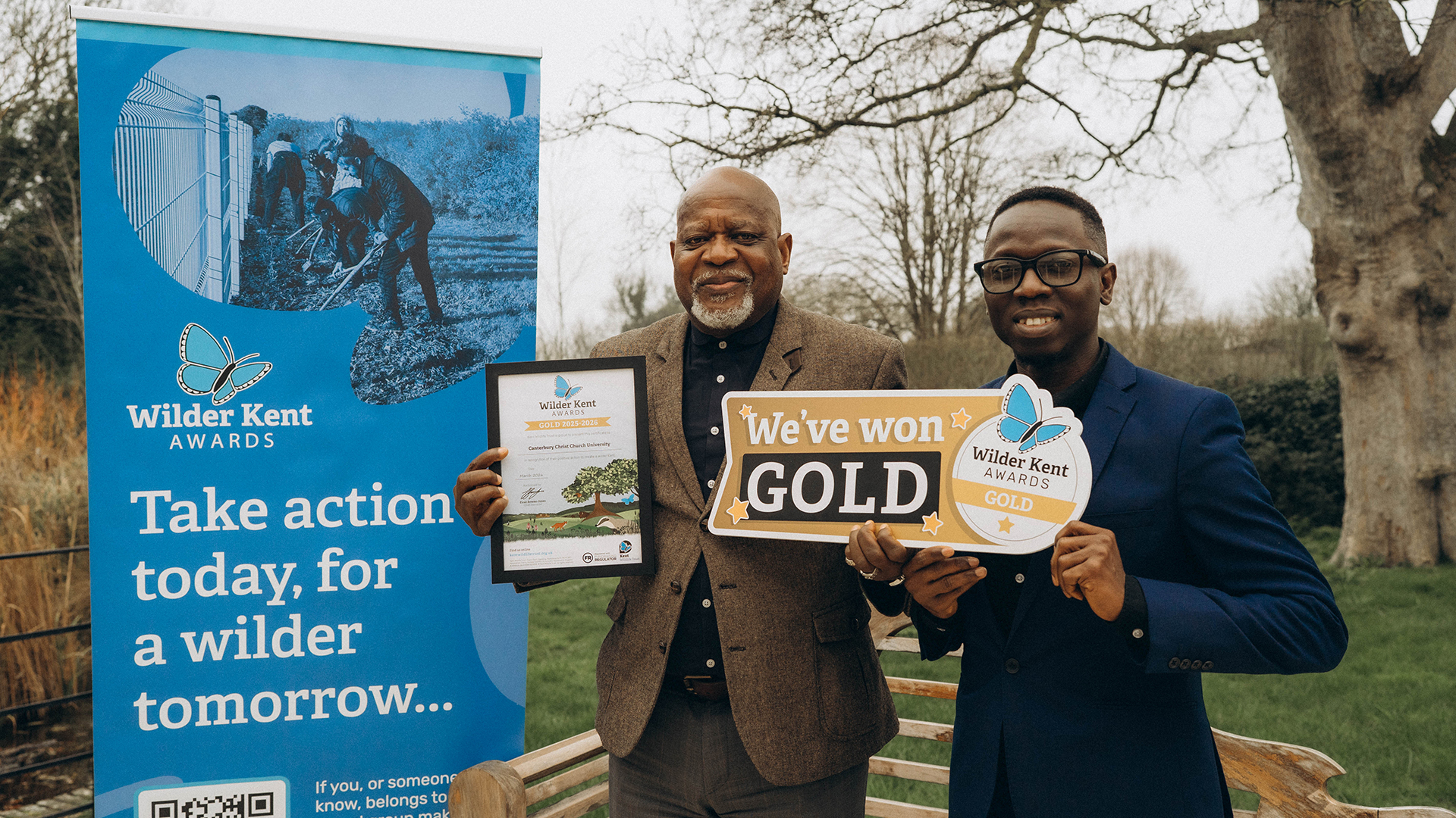 Two members of staff receiving a gold Wilder Kent Award