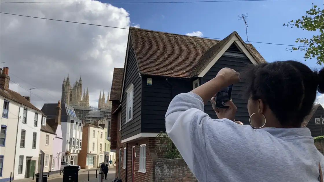 Photo of student taking a photo of an historic street in the city of Canterbury