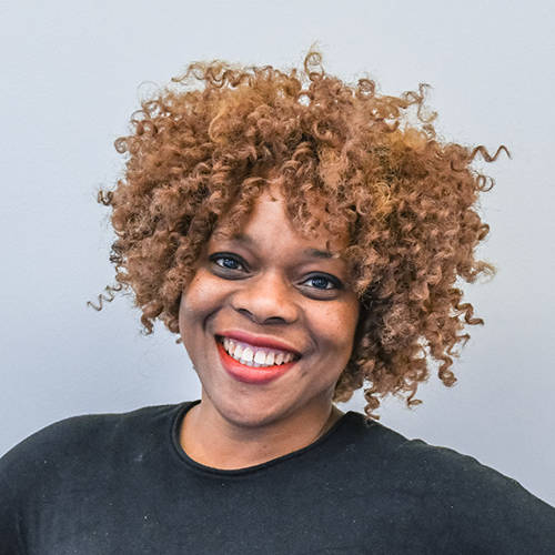 A support officer smiling at the camera.