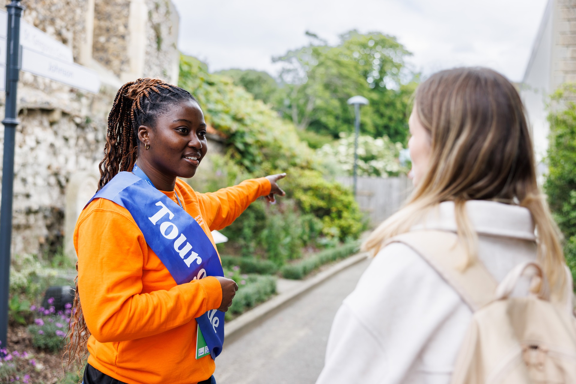 Student Ambassador helping a visitor during an Open Day. 