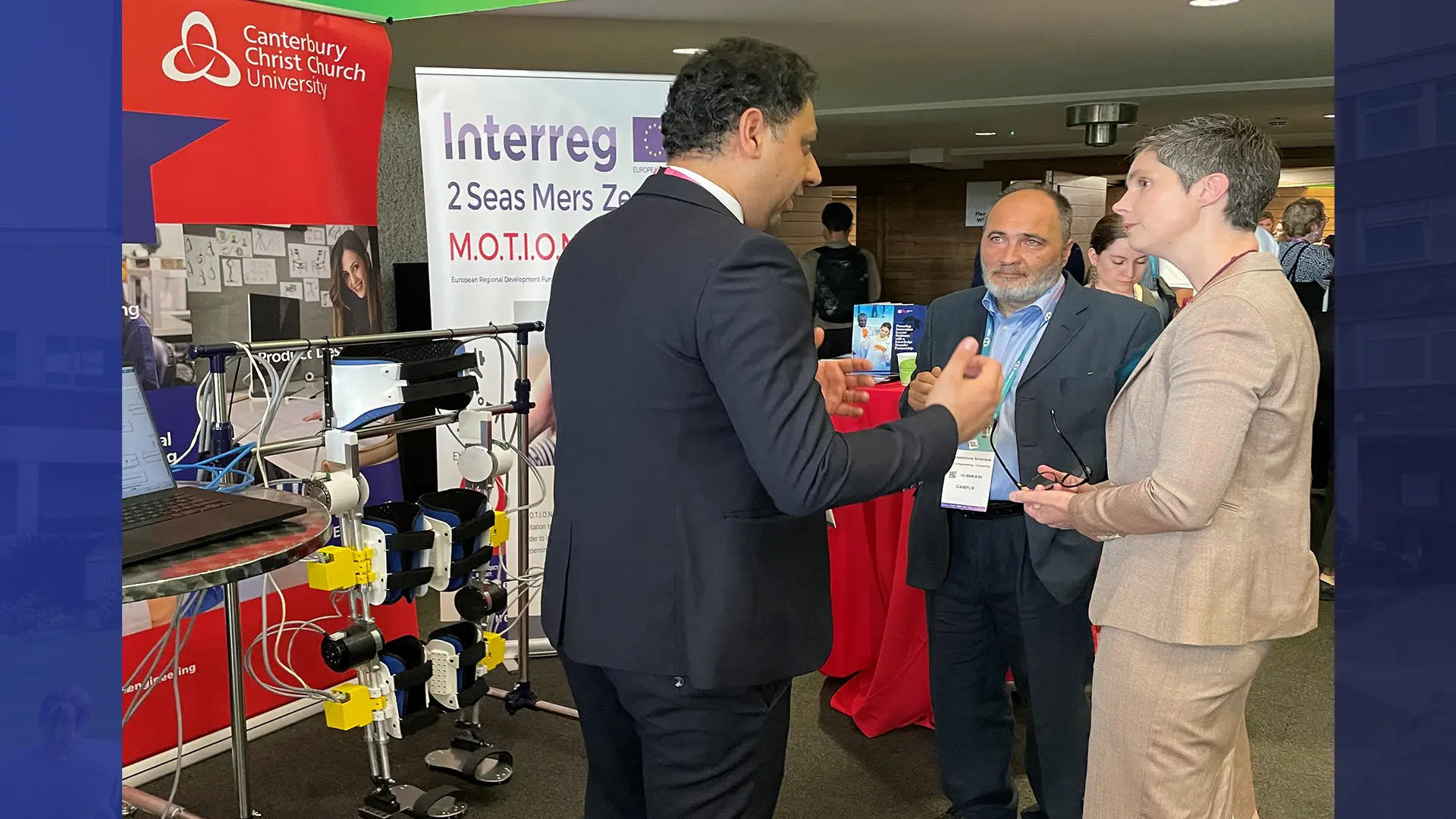 Mohammad Sarajchi and Professor Konstantinos Sirlantzis presenting the Exoskeleton to to Secretary of State for Science, Innovation and Technology, Rt Hon Chloe Smith MP