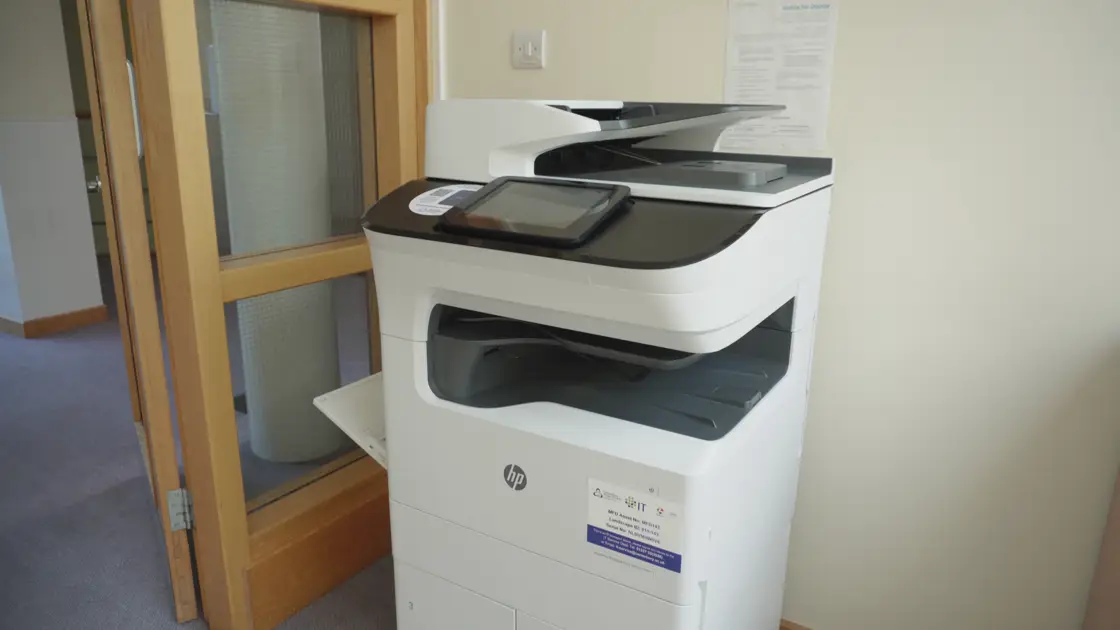 A campus MFD printer in a corridor.