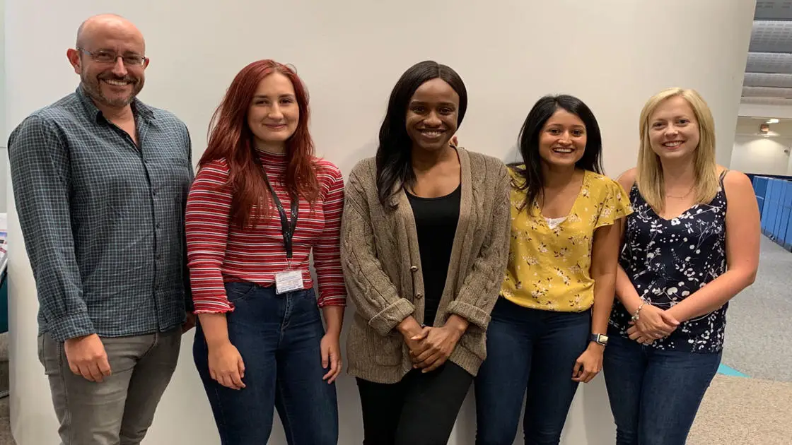 Simon Harvey (far left) and Katie Harvey (far right) with three of members of their lab, past and present: Lucy Vining, Naki Adjirackor and Anjali Mandawala (left to right)