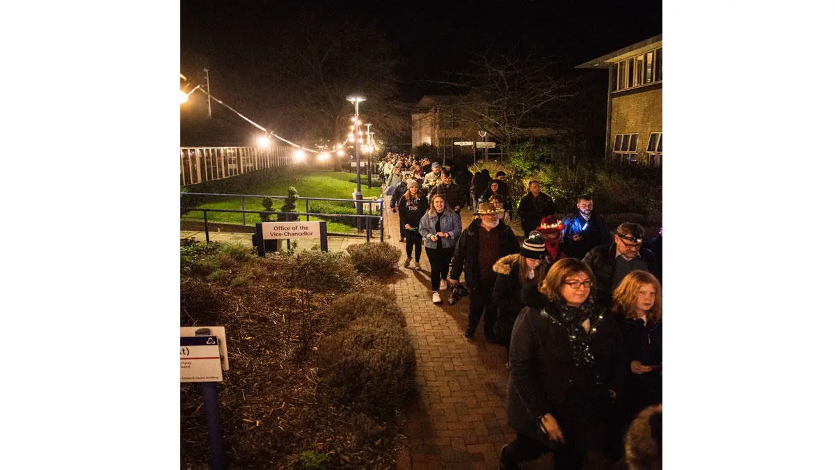 People walking through campus for Light Up the Night