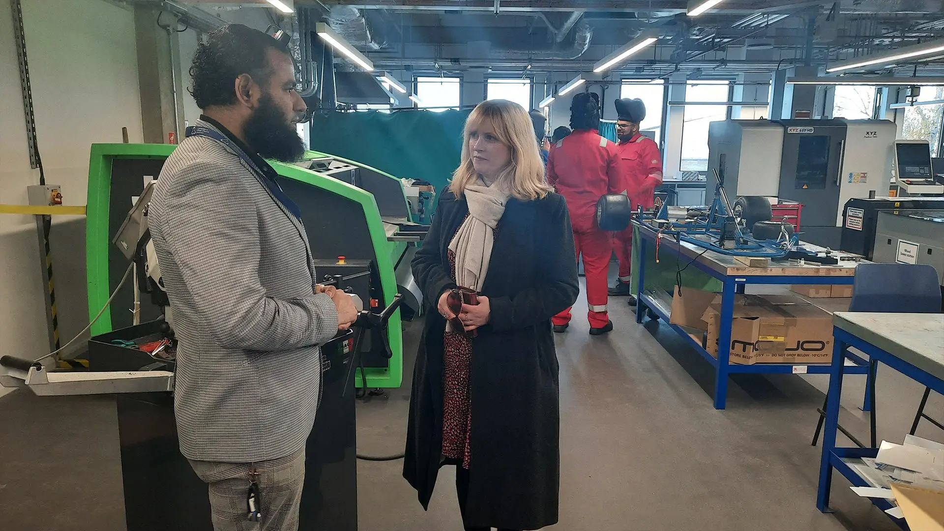 Rosie Duffield MP talking with Engineering staff in a lab 