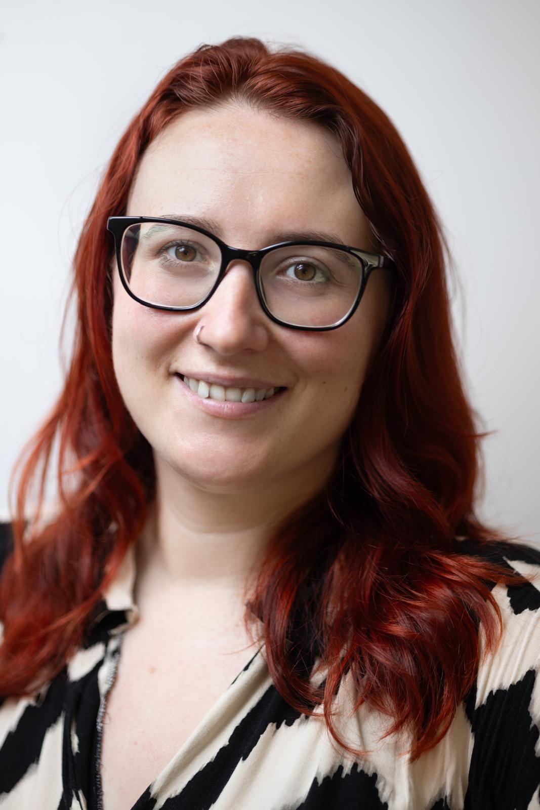 A headshot of Michelle England who is smiling at the camera