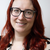 A headshot of Michelle England who is smiling at the camera
