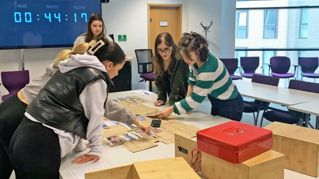 A team of students are taking part in the Climate Escape Room.
