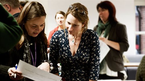 Photograph of people having a discussion.